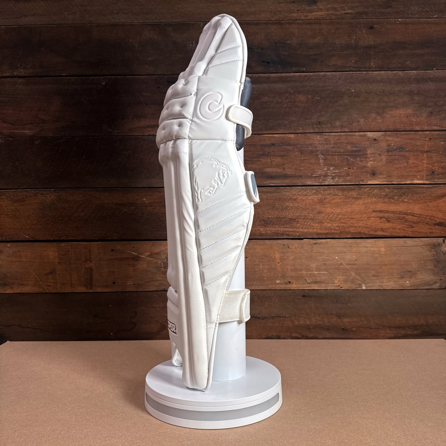 Bison youth cricket pads in white, showcasing premium foam design and adjustable straps for secure fit.