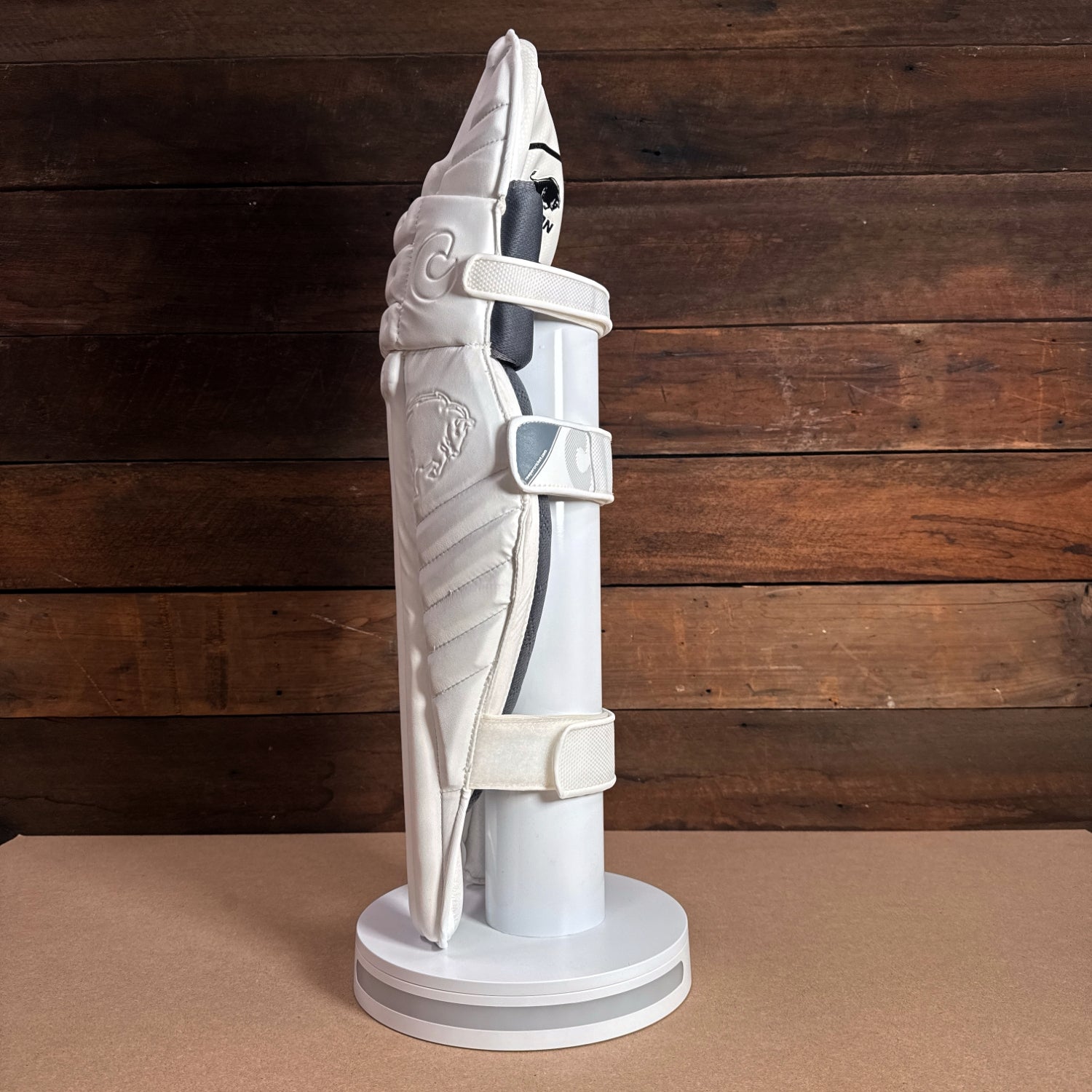 BISON PADS 2024-25 youth cricket pads displayed on a stand, showcasing premium foam construction and sleek design.