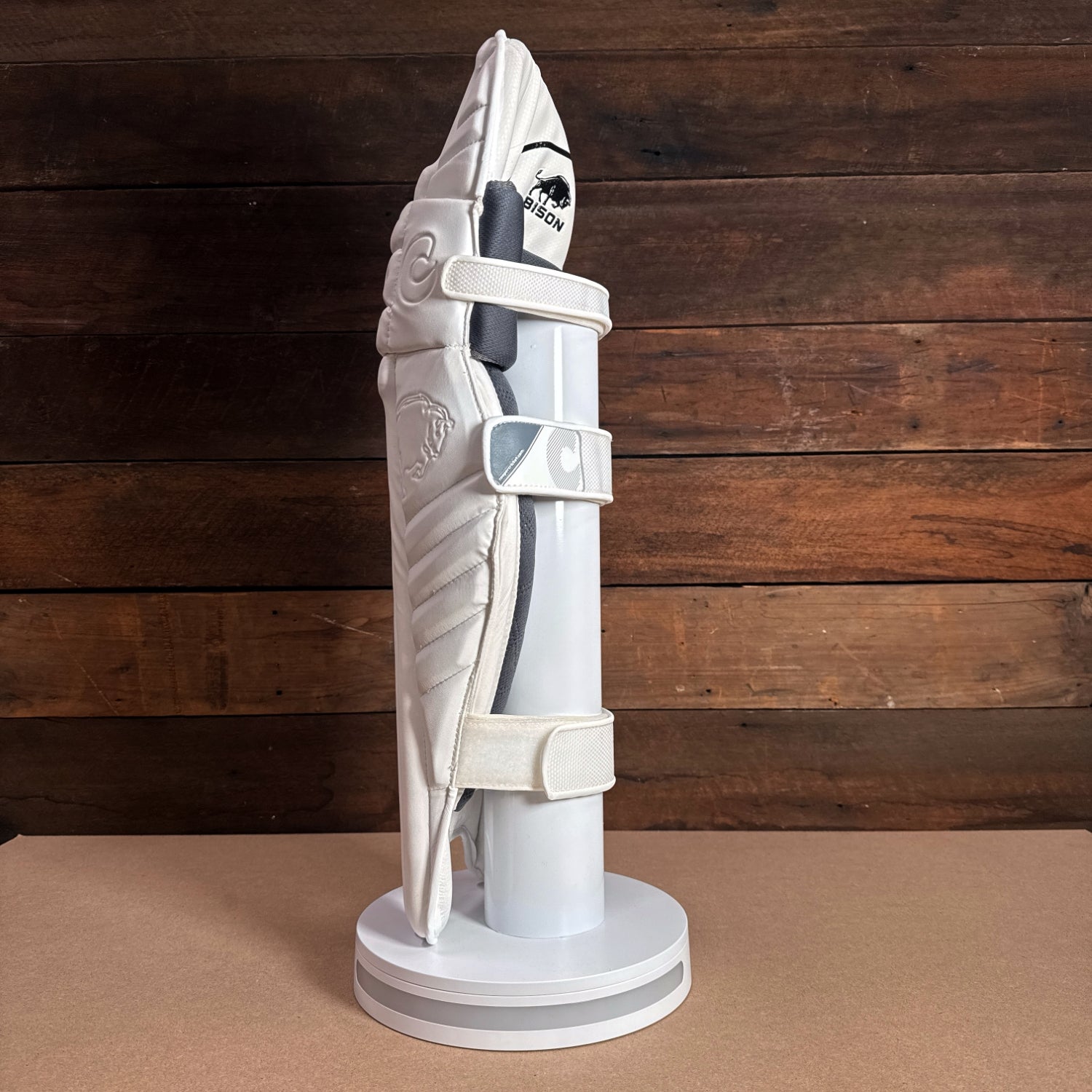 Bison Cricket Pads 2024-25 Youth model displayed on a stand, featuring premium protection and modern design.