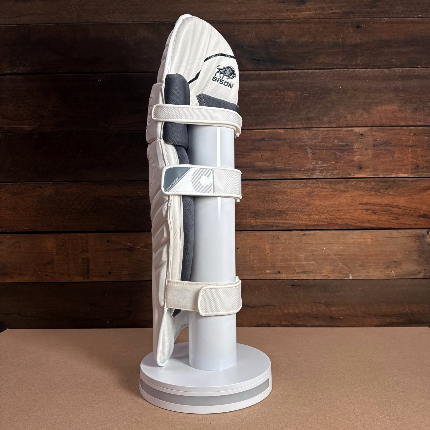 Bison Youth Cricket Pads displayed on a stand, showcasing premium padding and modern design for enhanced protection.