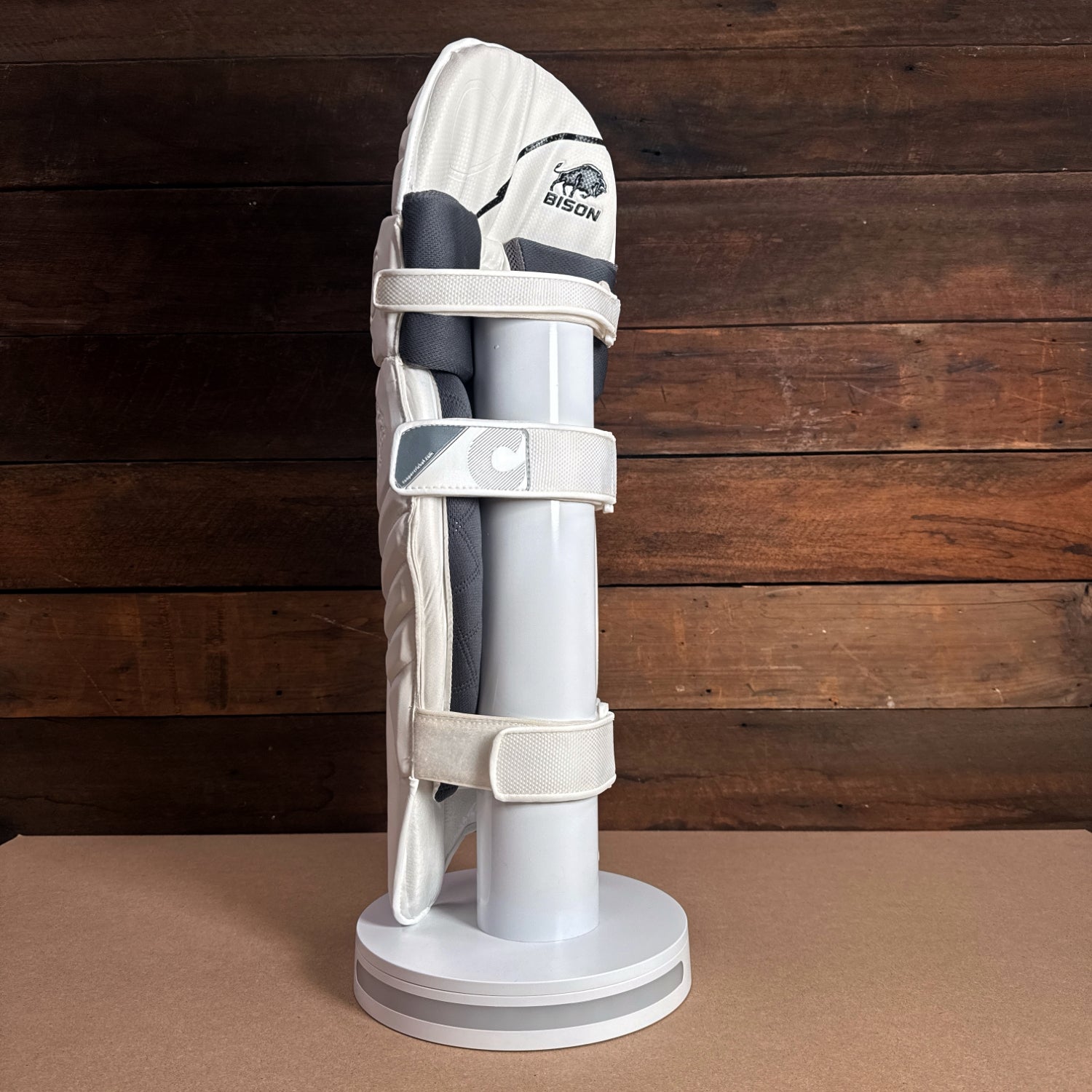 Bison Cricket Pads 2024-25 Youth model showcasing premium protection and modern design on display stand.