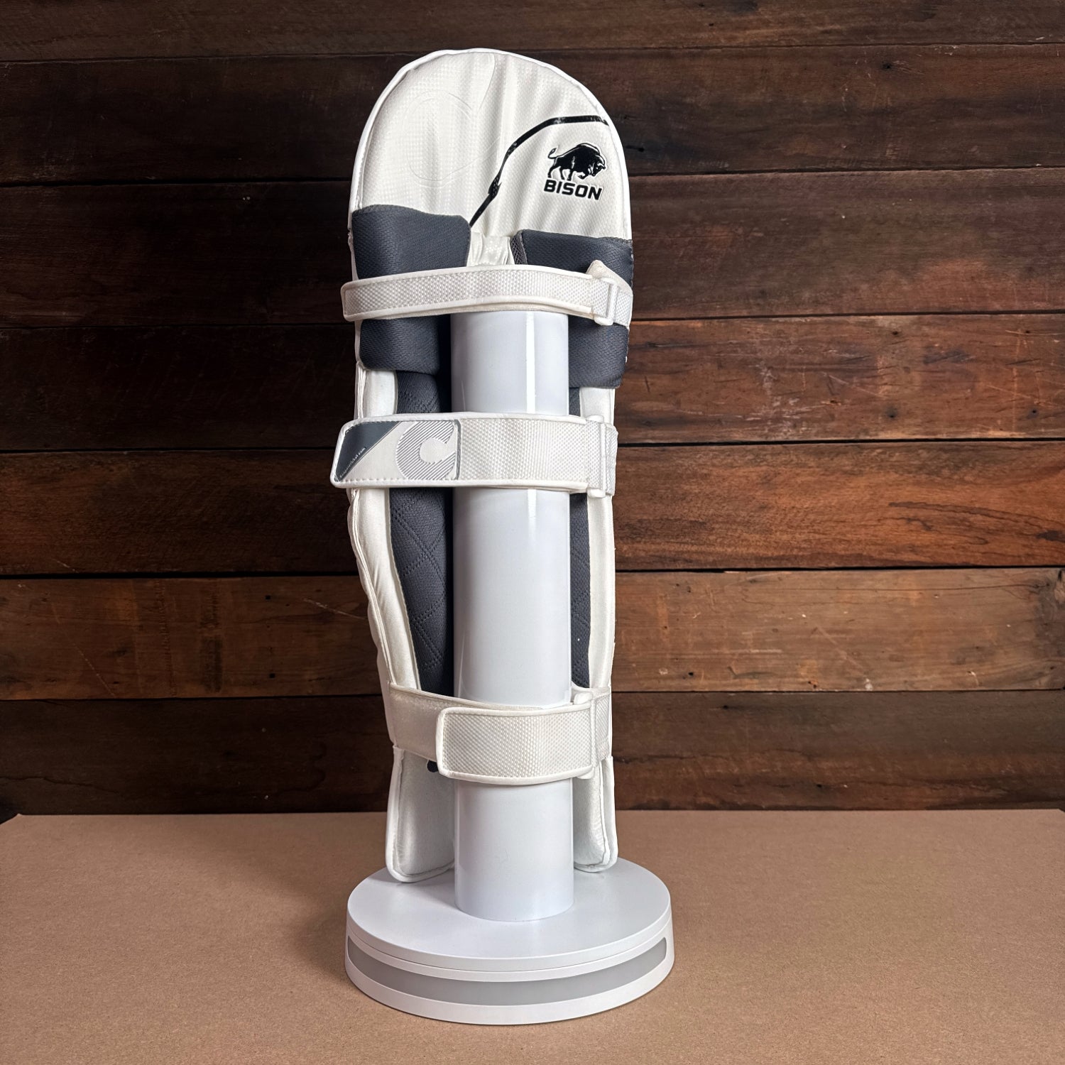 Bison Cricket Pads 2024-25 Youth, showcasing premium protection and modern design on display stand.