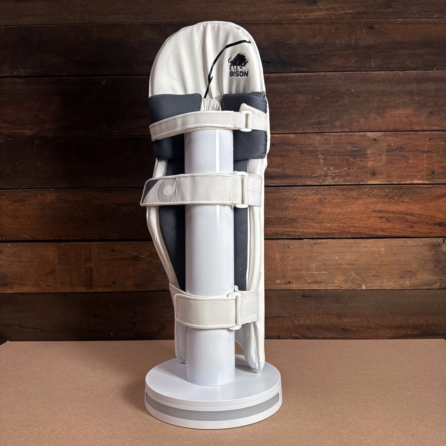 Bison Cricket Pads 2024-25 Youth model displayed on a stand with premium foam and strap features.