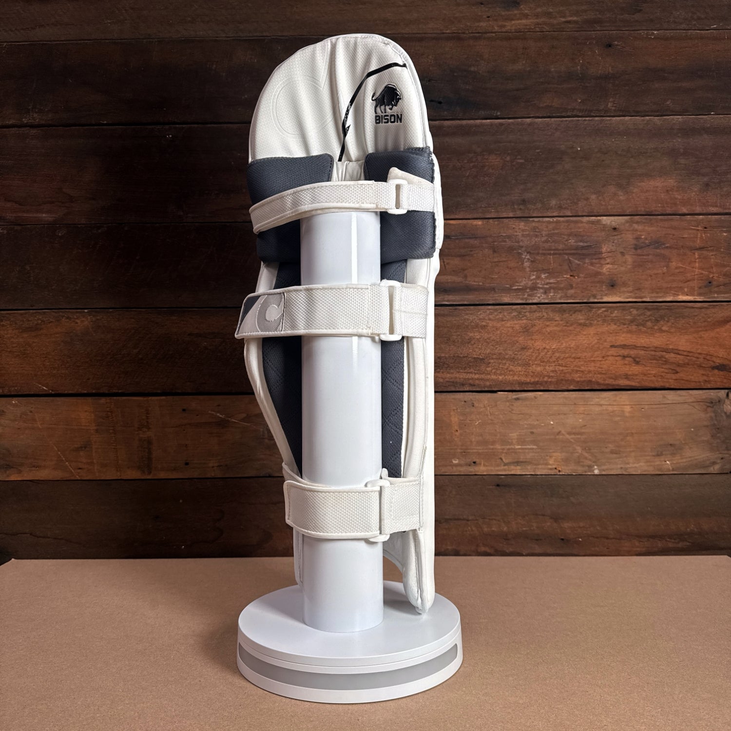 Bison youth cricket pads displayed on a stand, showcasing premium protection and sleek design for the 2024-25 season.