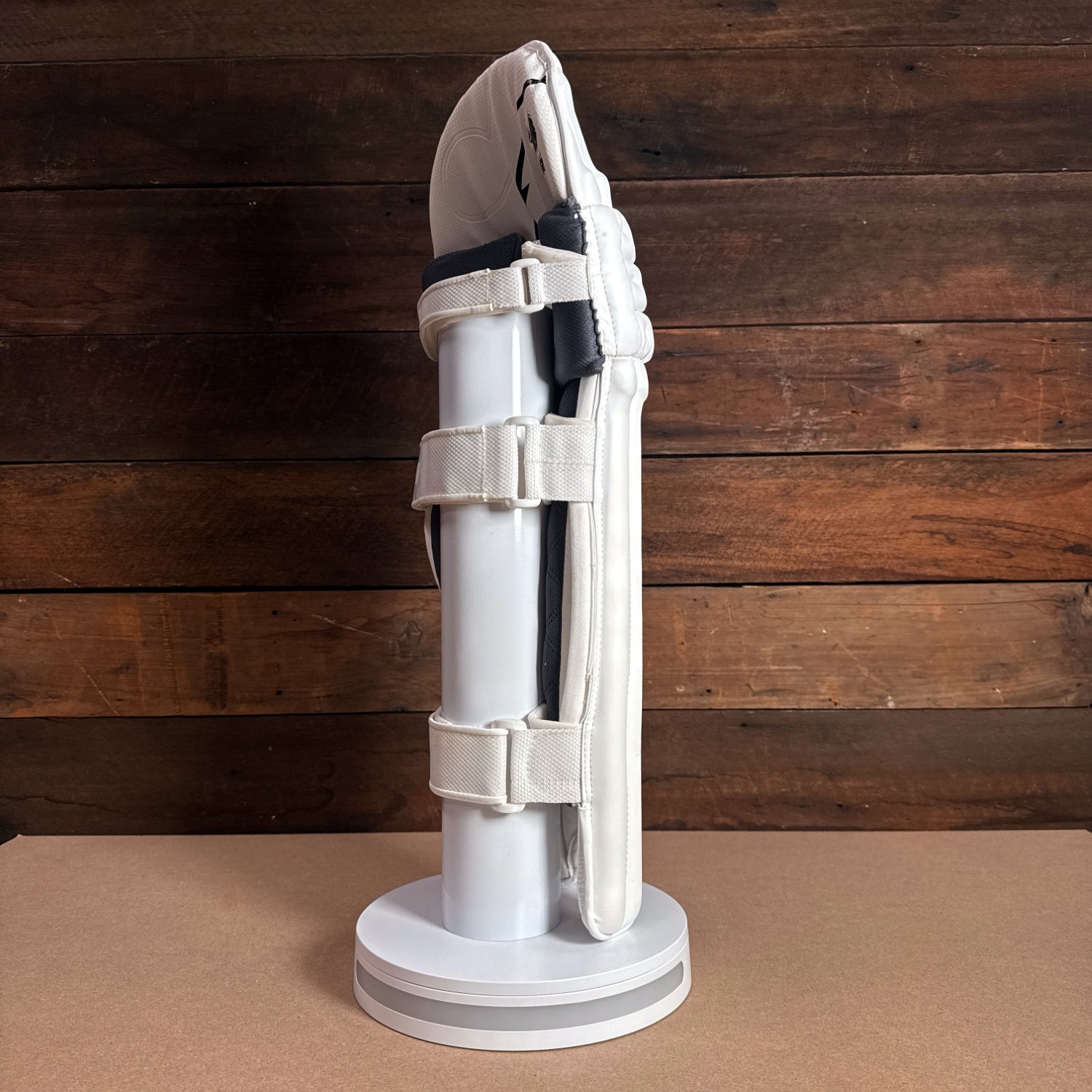 Bison Youth Cricket Pads displayed on a stand, showcasing premium foam and secure strap design for optimal protection.