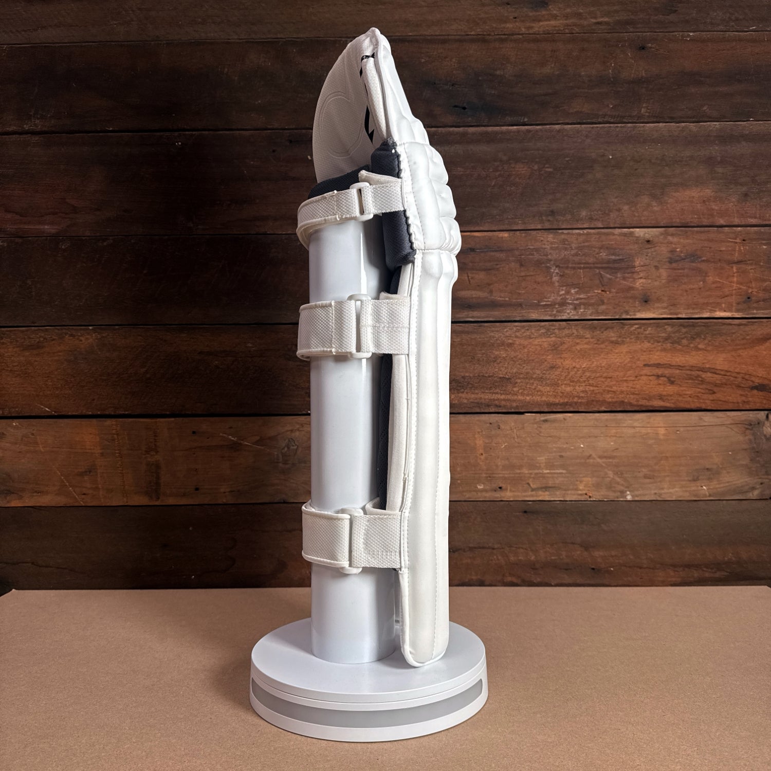 BISON PADS 2024-25 Youth Cricket Pads displaying side view on a stand, showcasing premium design and secure fit.