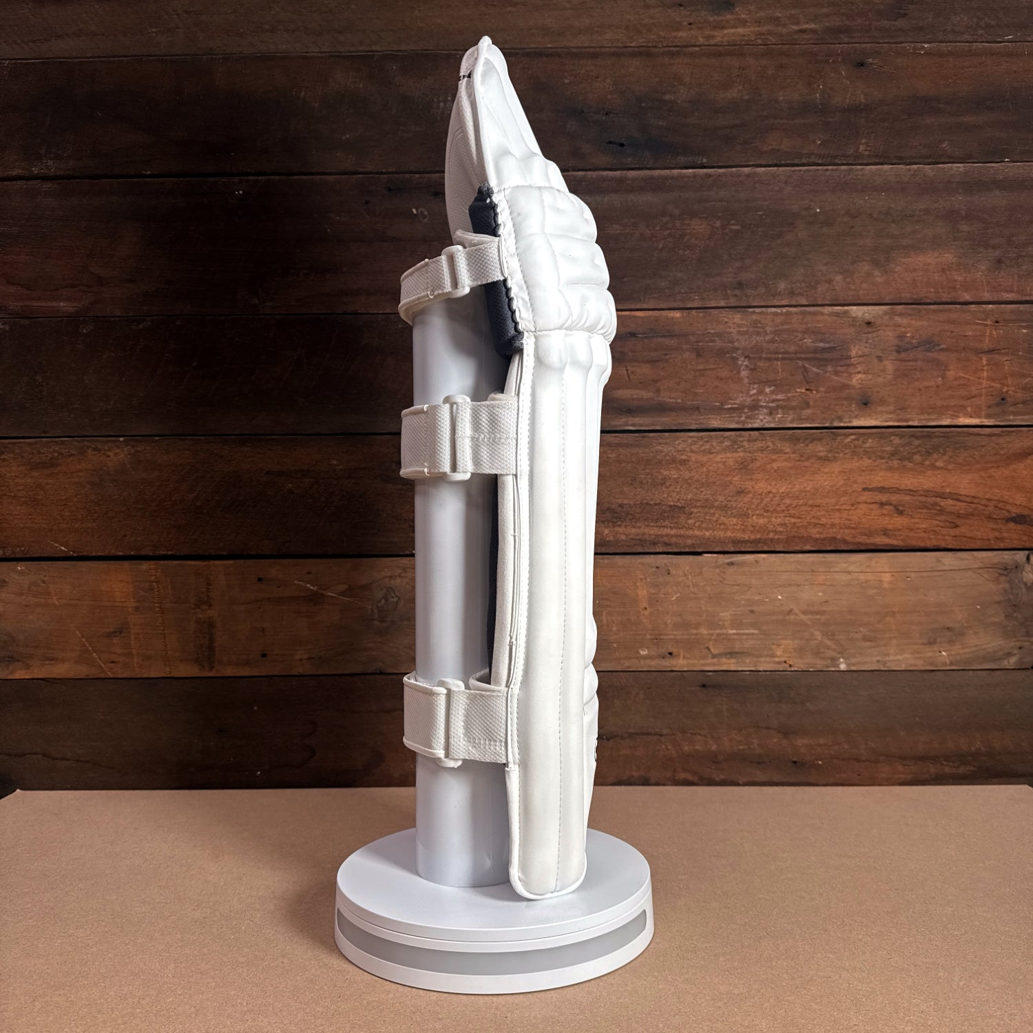 Bison Cricket Pads 2024-25 youth model, showcasing premium protection and snug fit on a display stand.