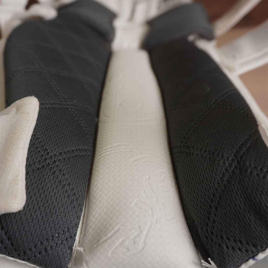 Close-up of Bison Cricket Pads' premium foam layers in black and white, showcasing sleek design and protection.