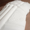 Close-up of Bison Cricket Pads showcasing premium white foam and embossed bison logo for enhanced protection.