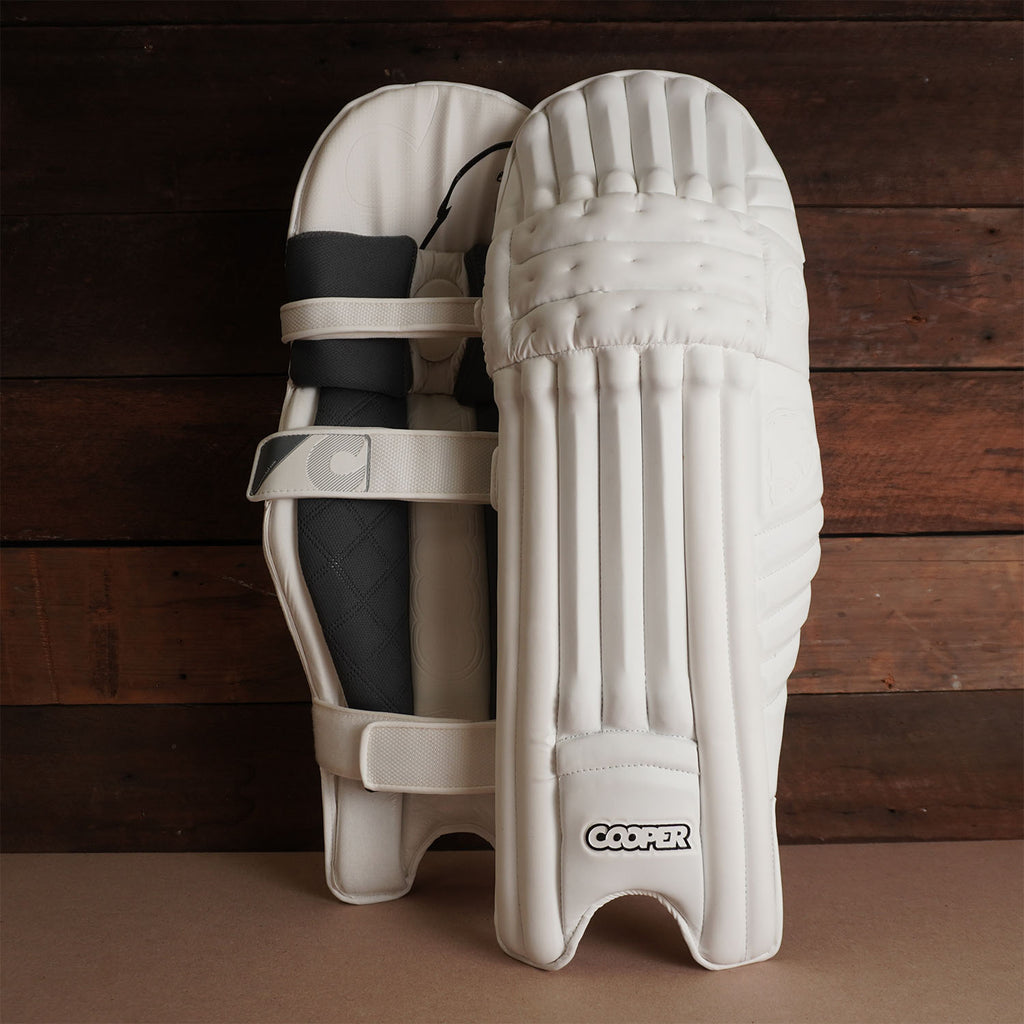 Bison Cricket Pads 2024-25 Youth, premium foam construction for top protection and comfort, featuring sleek white design.