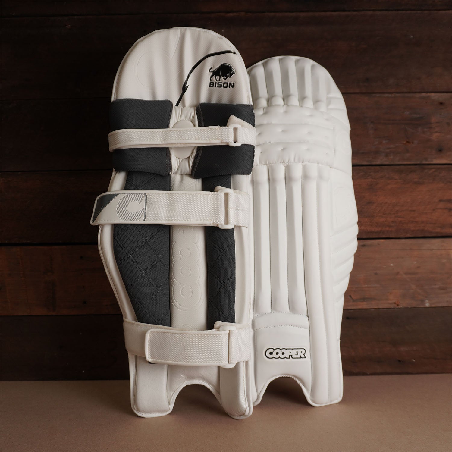 Bison Cricket Pads 2024-25 in white with adjustable straps, offering premium protection for youth players.
