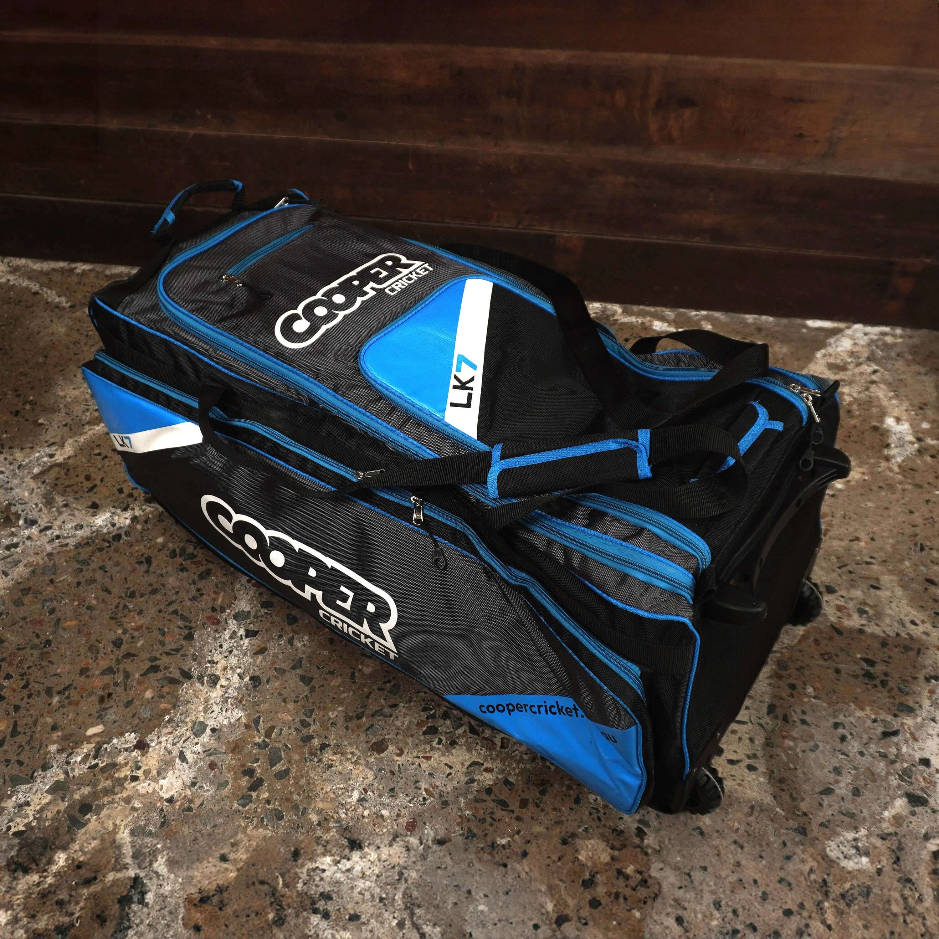 LK7 cricket bag in blue and black with multiple compartments, designed for organized cricket gear storage.