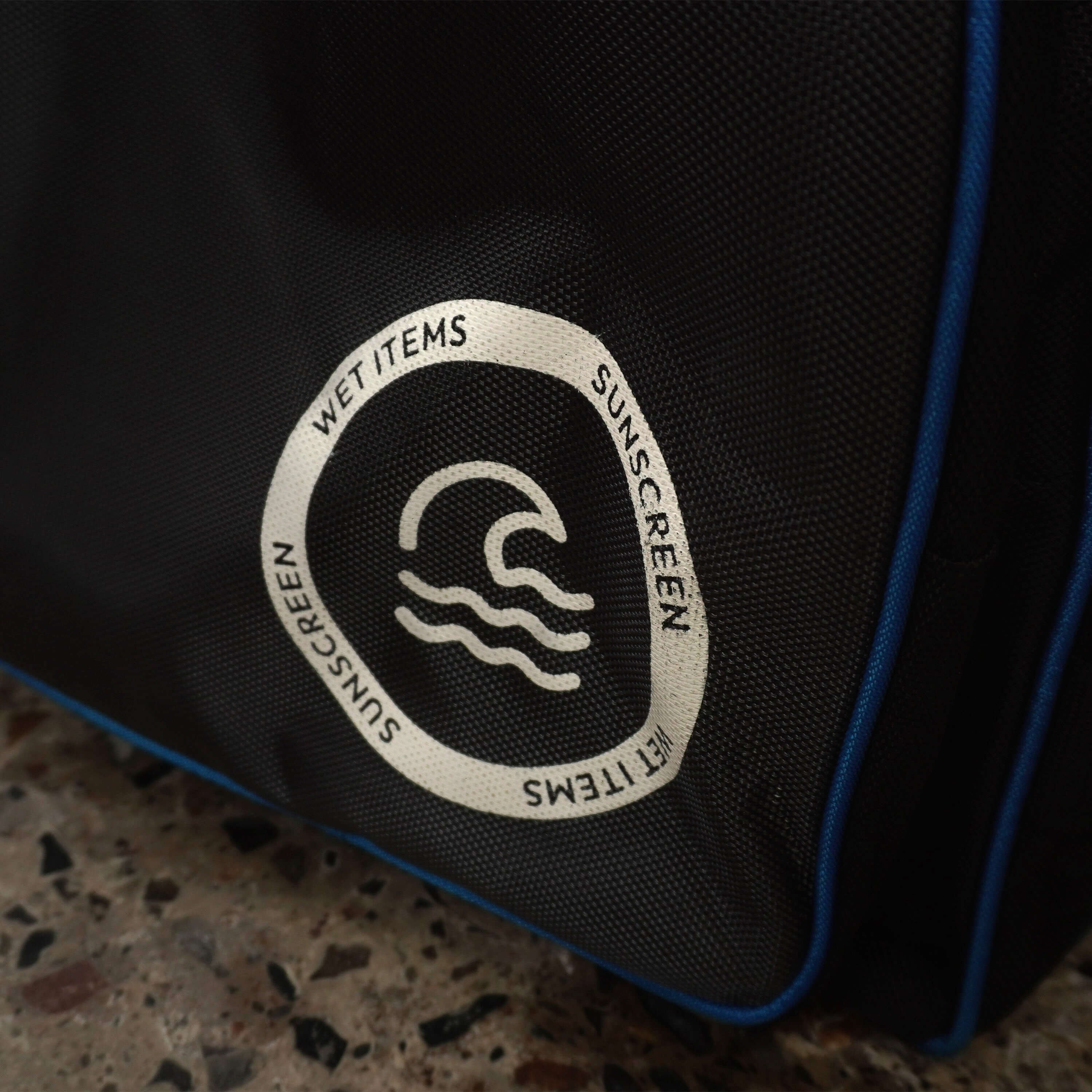 Close-up of pocket label for wet items and sunscreen on an LK7 cricket bag.