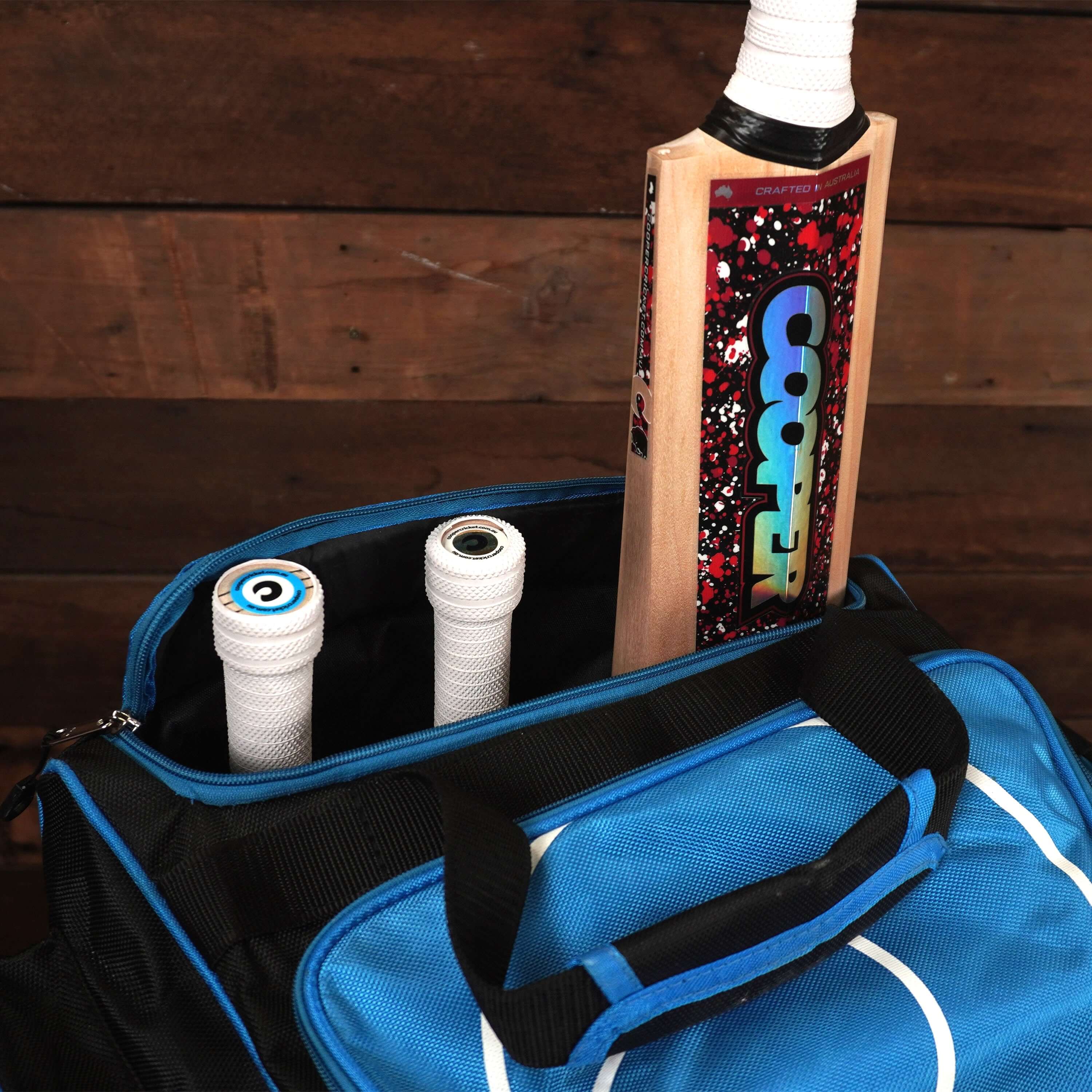 Blue LK7 cricket bag with multiple compartments, showcasing cricket bats stored inside, ideal for organized gear storage.