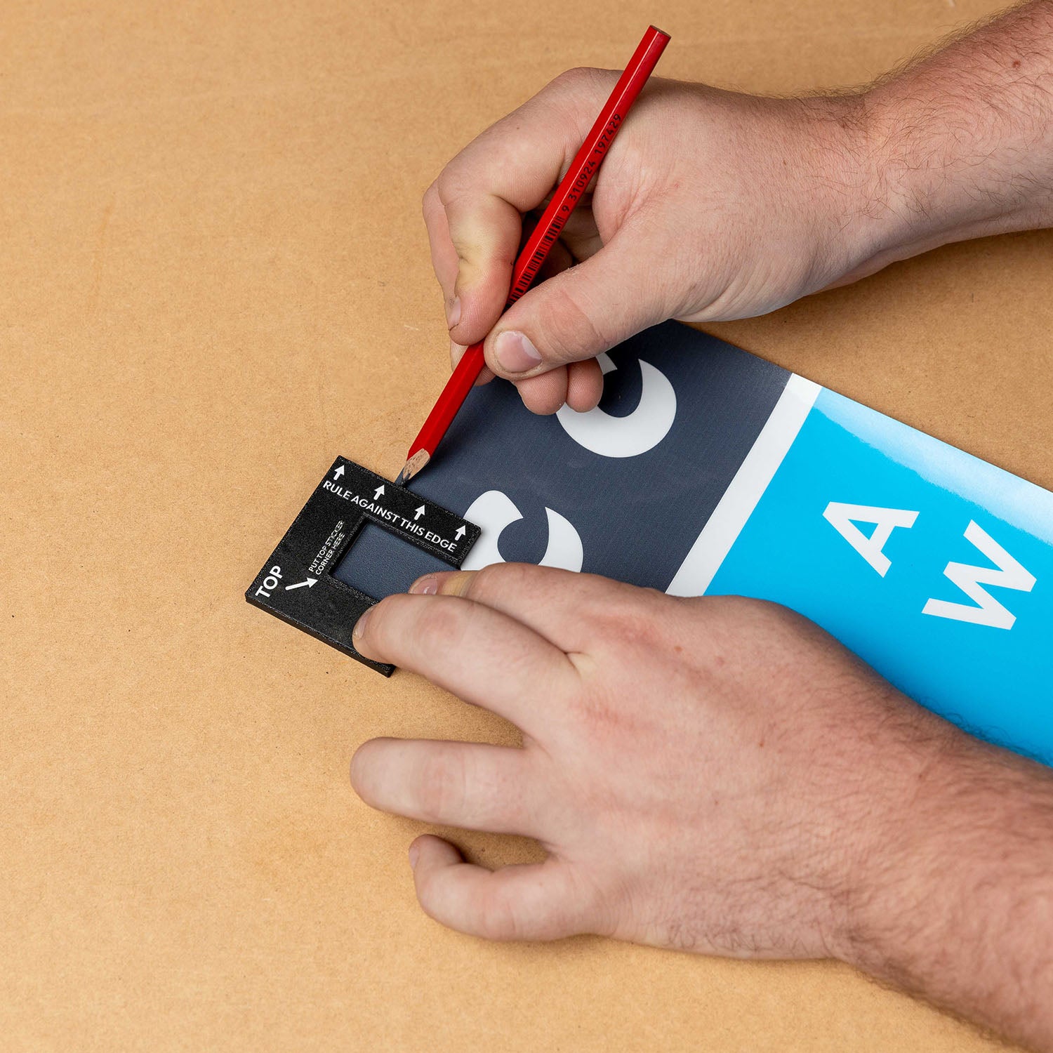 Cricket stump marker tool in use for precise alignment of custom stump stickers on a blue surface.
