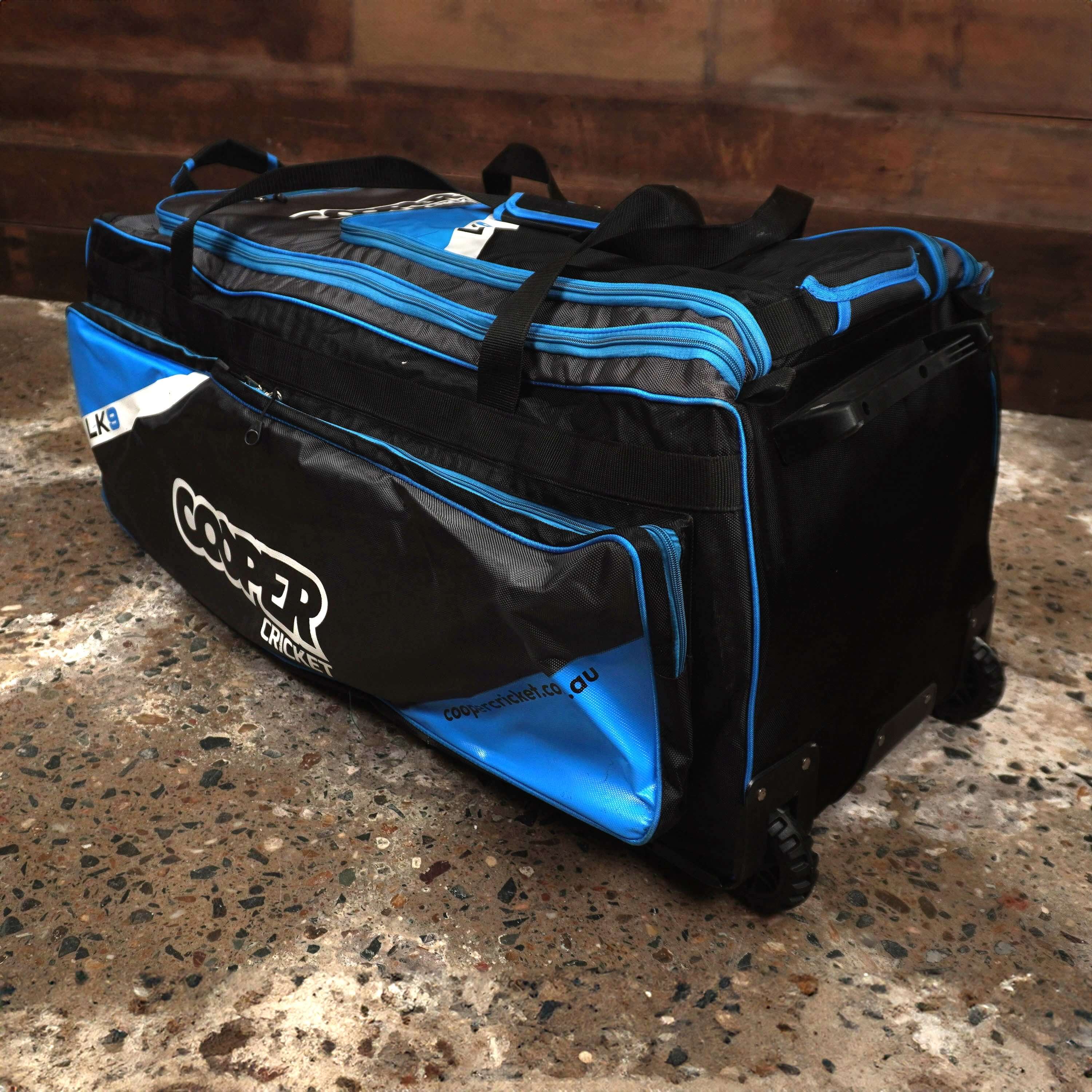 Large LK9 cricket bag with multiple compartments for gear storage on a textured floor.