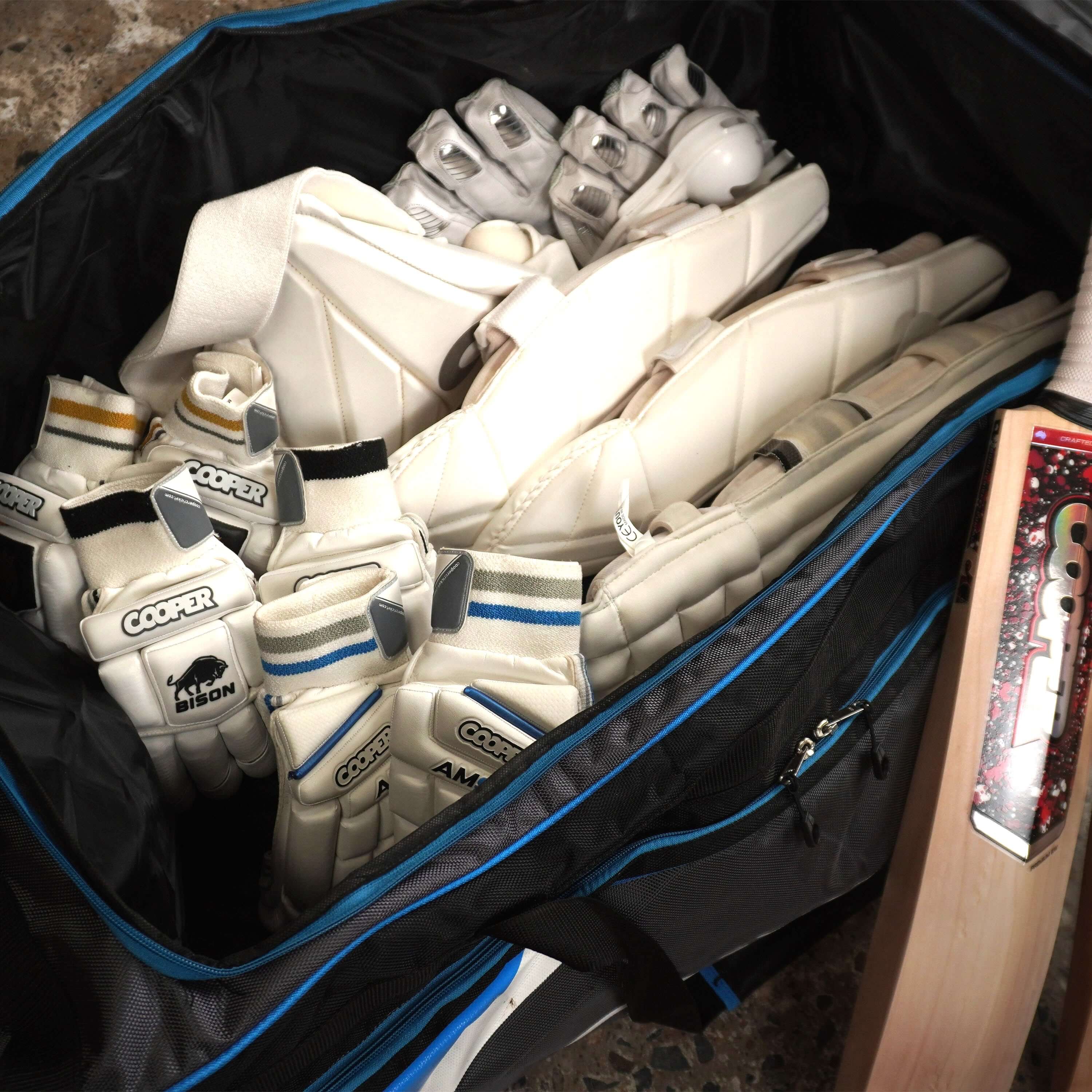 LK9 cricket bag filled with cricket gloves, pads, and a cricket bat, showcasing ample storage for essential cricket gear.