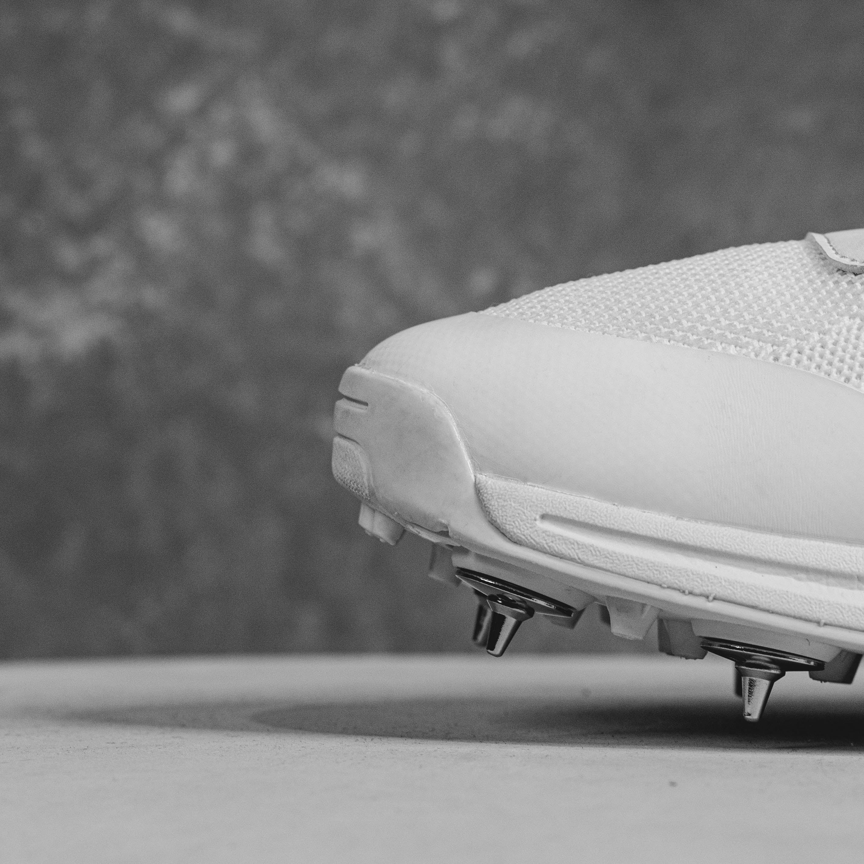 Close-up of Idoneus ID1 Cricket Shoe with steel spikes for superior grip and stability on the field.