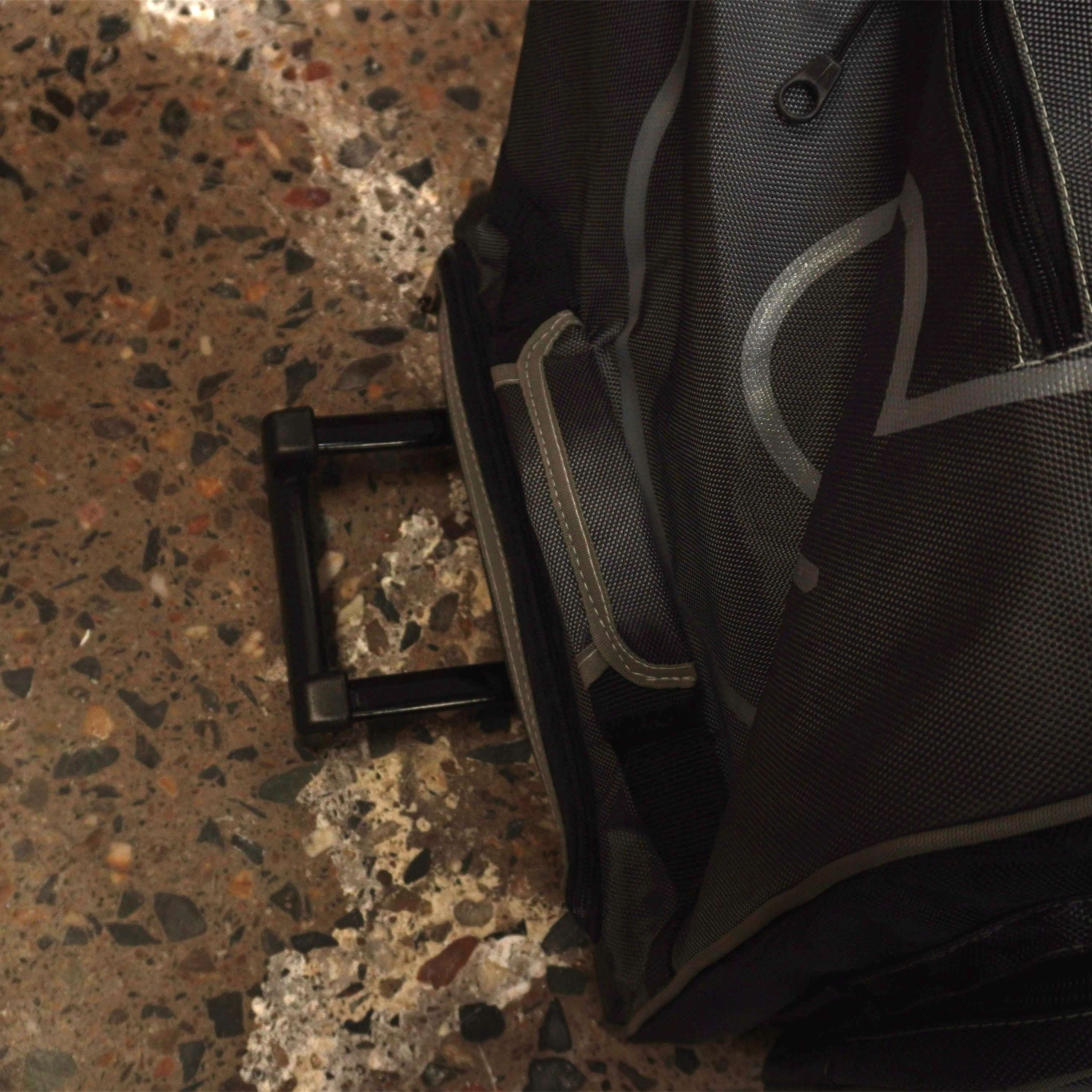 LX9 Cricket Bag with pull-out handle on stone floor, designed for easy transport of cricket kit essentials.