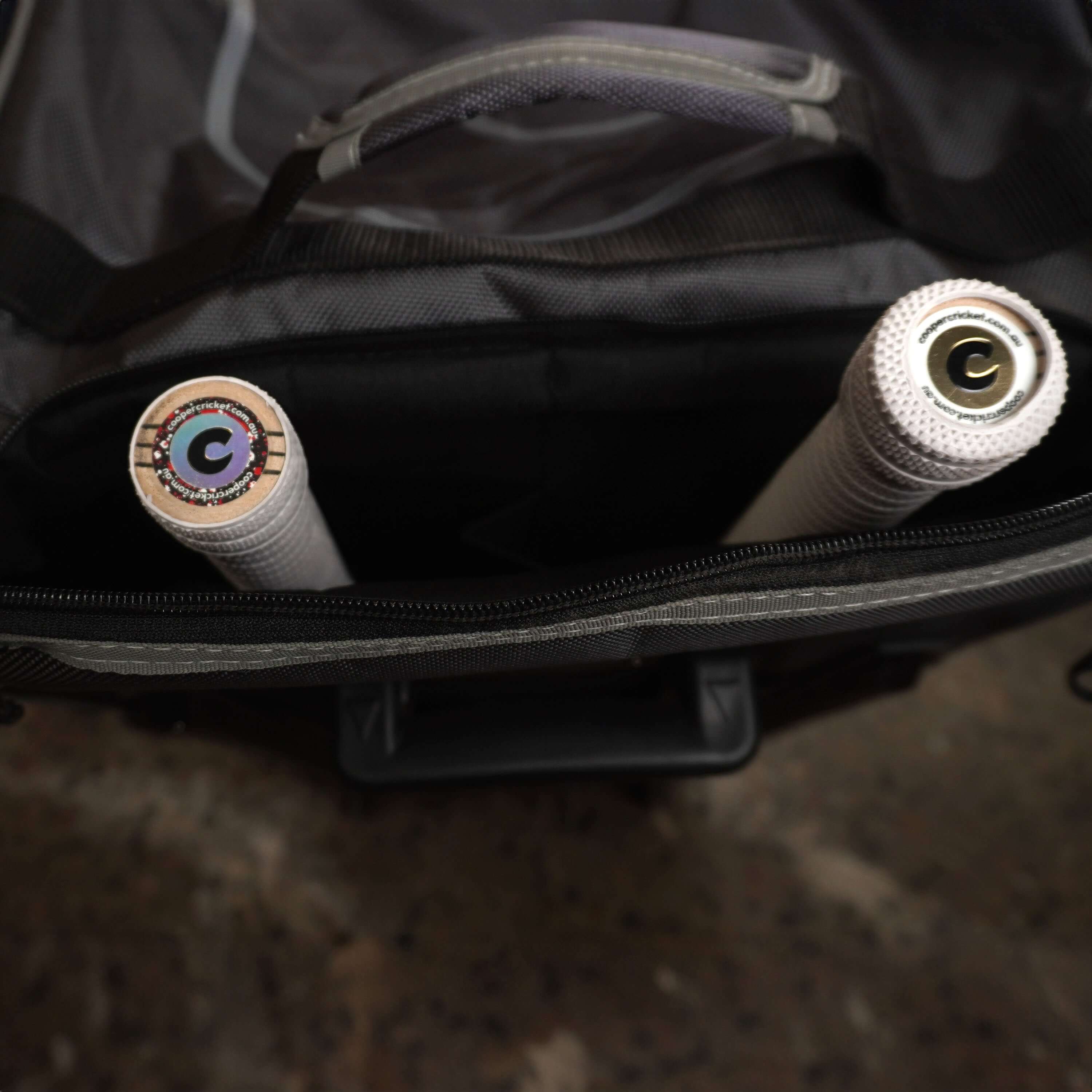 LX9 cricket bag with two bats inside, showcasing spacious interior for cricket kit essentials.