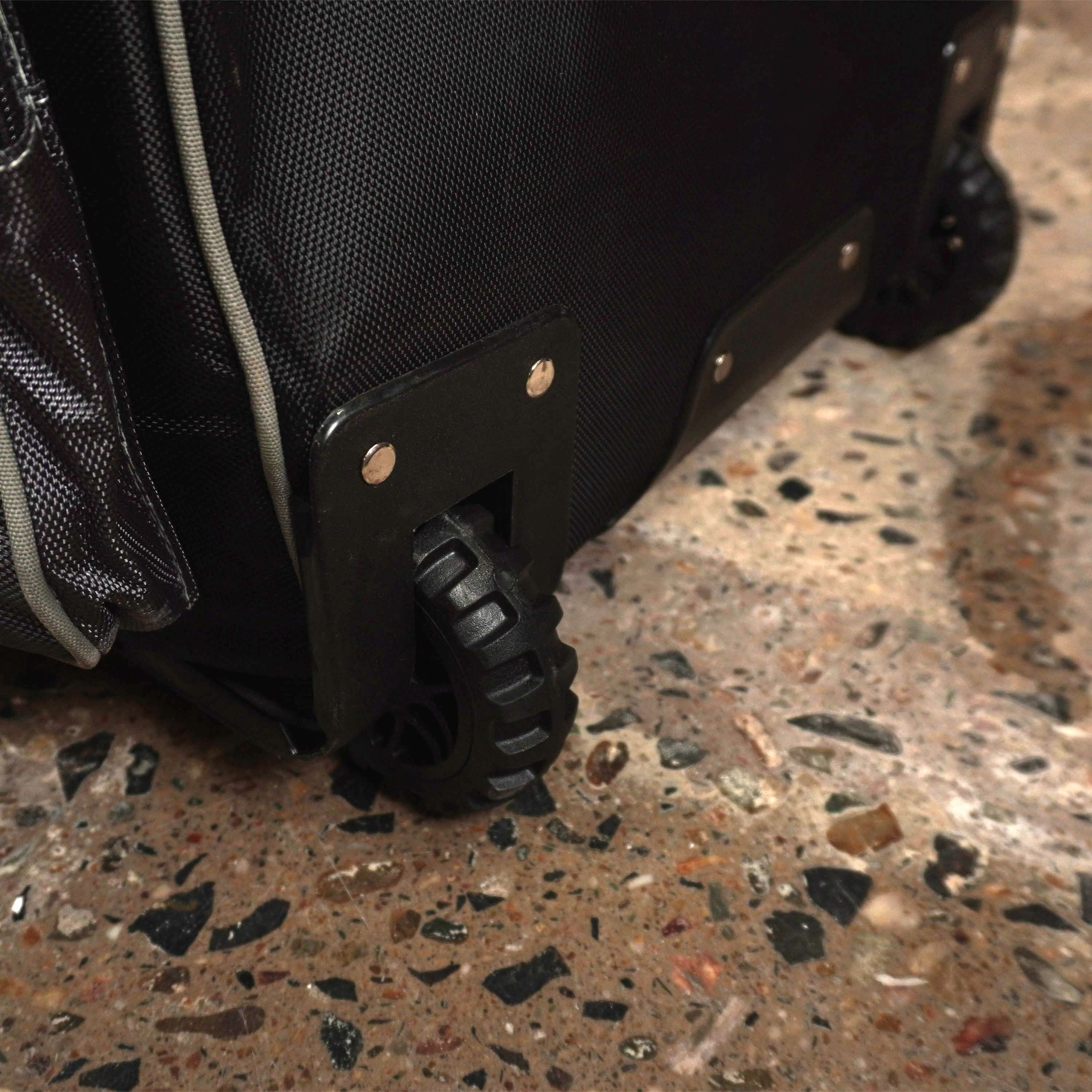 Durable wheels on LX9 cricket bag for easy transport of cricket kit on rocky surface.