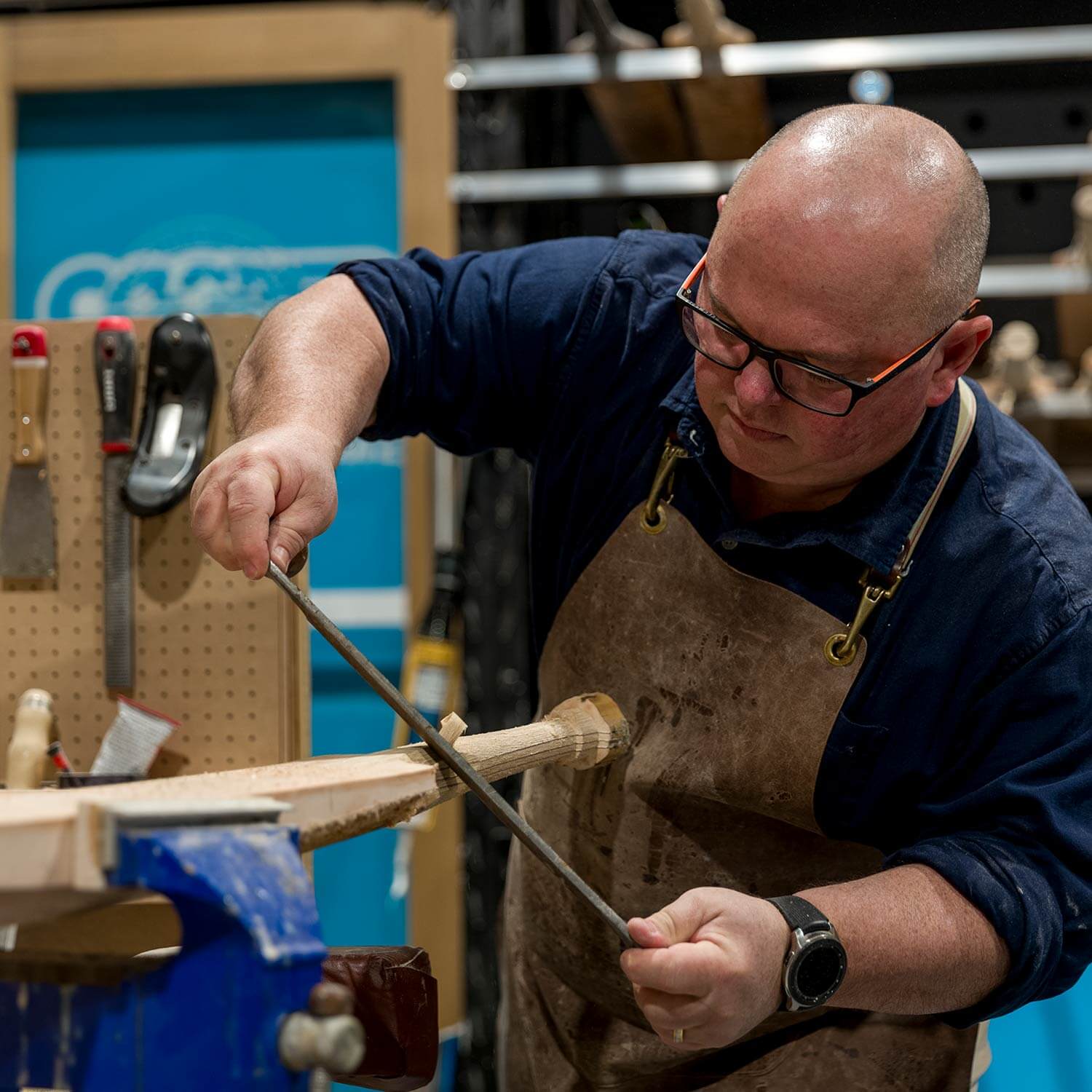 Rod Grey of Cooper Cricket shaping a handle of a cricket bat