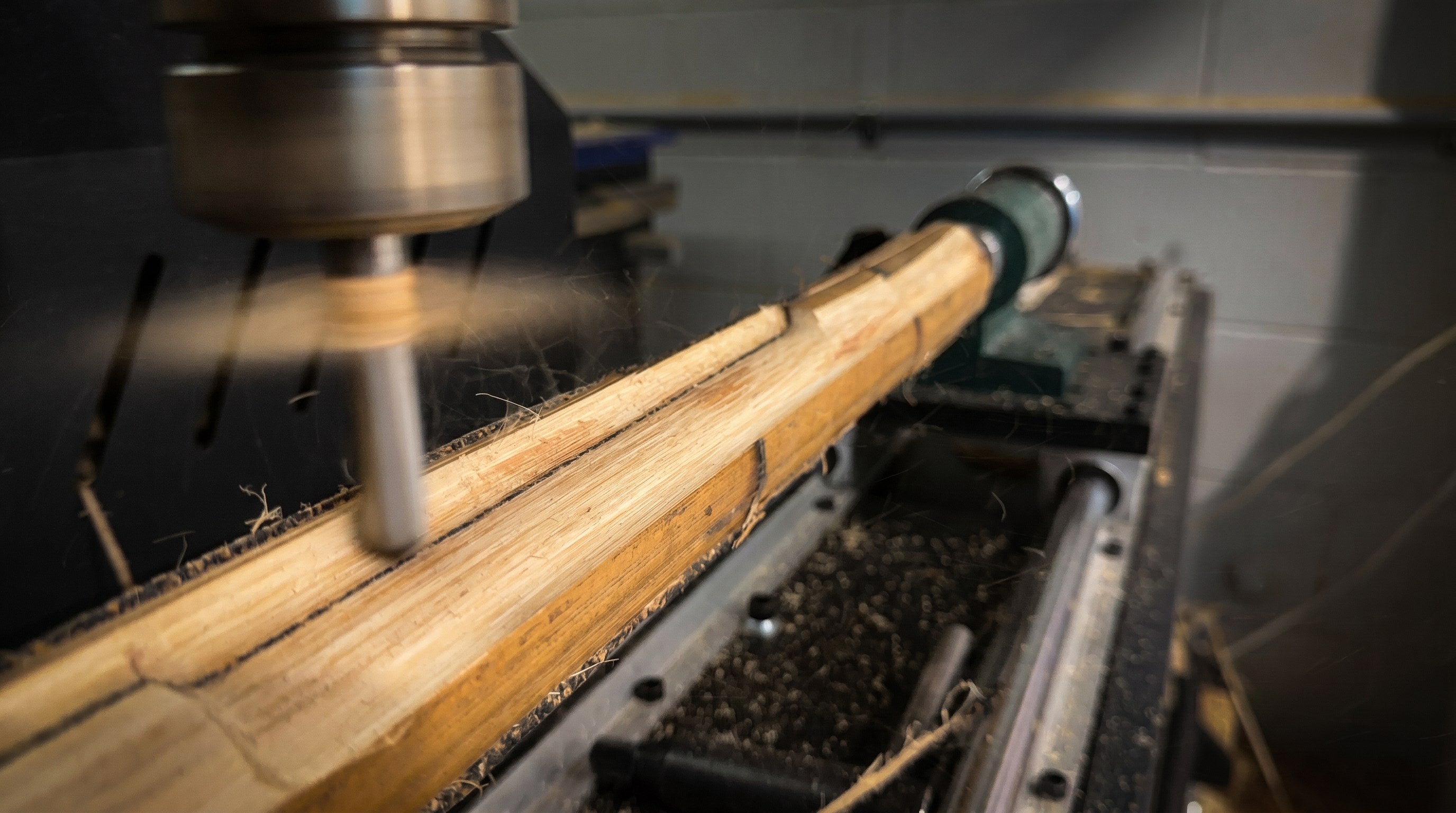 CNC machine shaping a Cooper bat handle