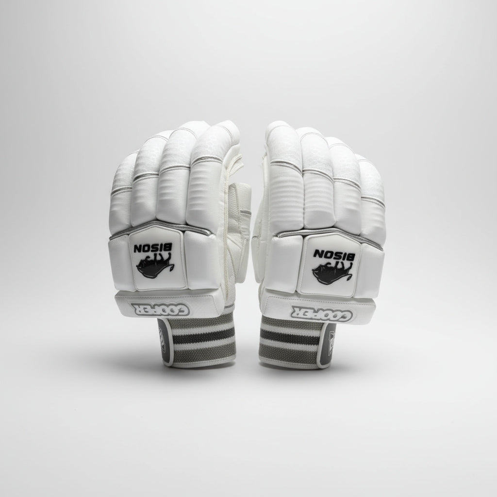 Pair of white cricket gloves with black Bison logos on a light gray background