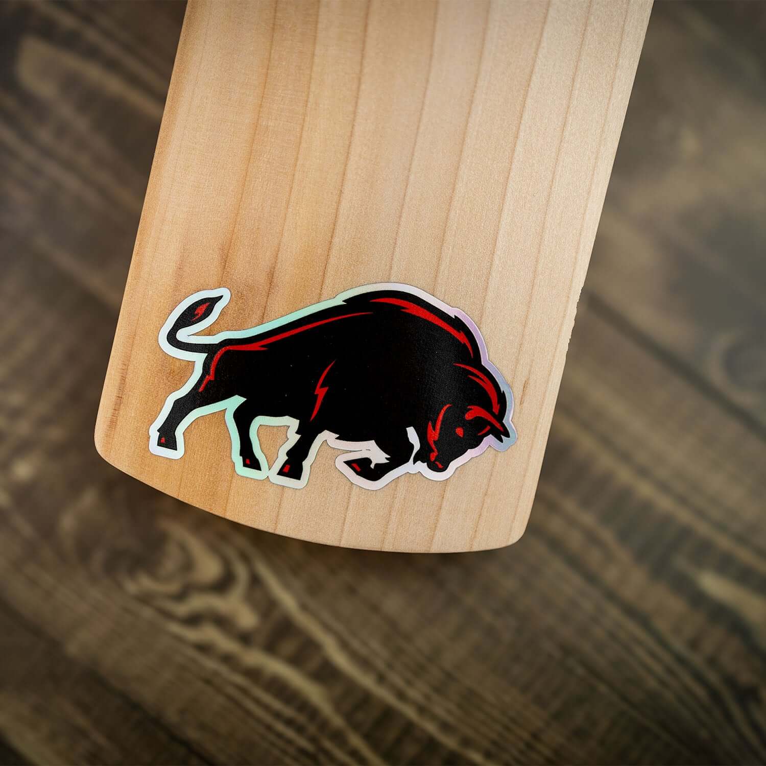 Close-up of the JB140 Limited Edition cricket bat featuring a striking black and red bull logo on the handle.