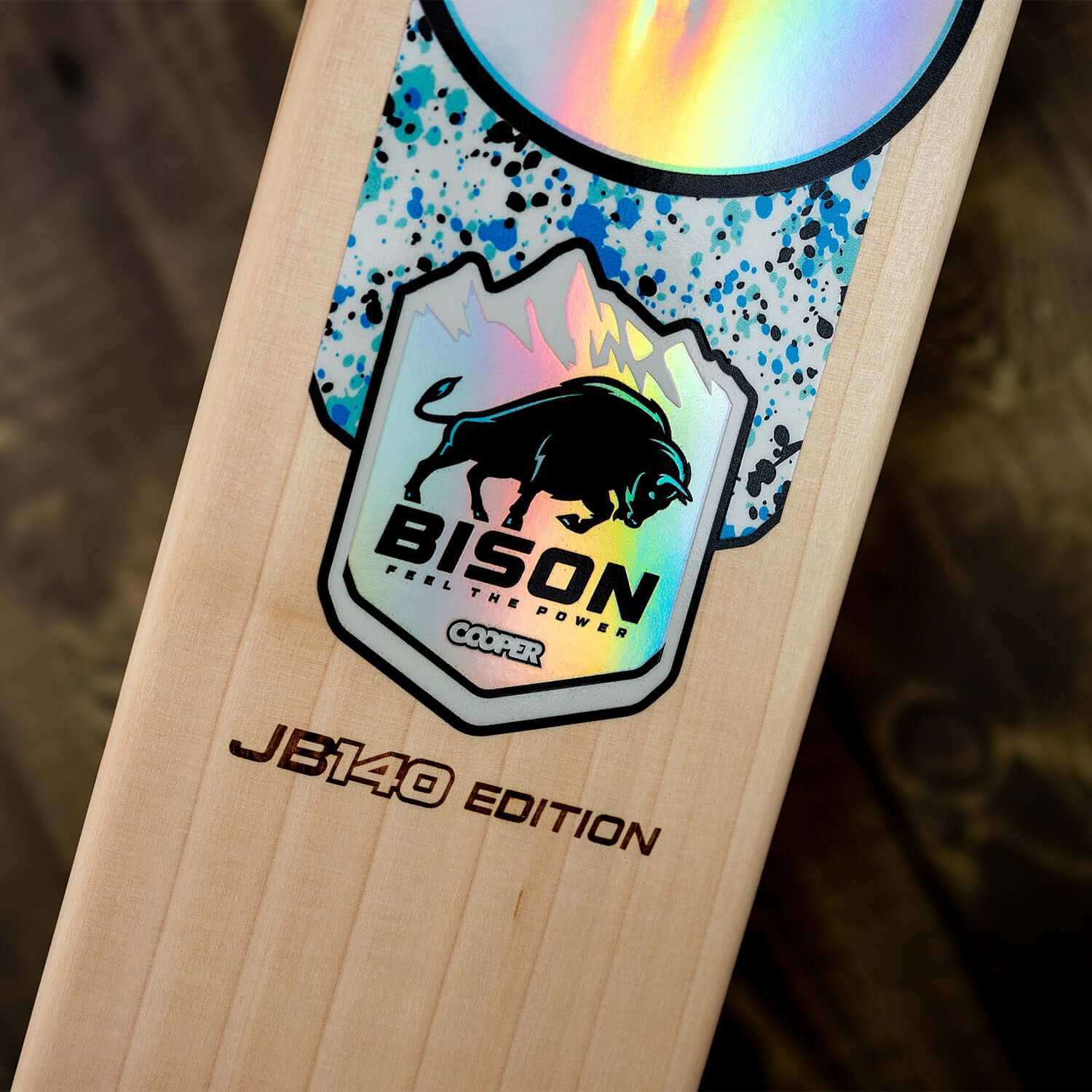 Close-up of JB140 Limited Edition cricket bat logo featuring Bison branding and vibrant design elements.