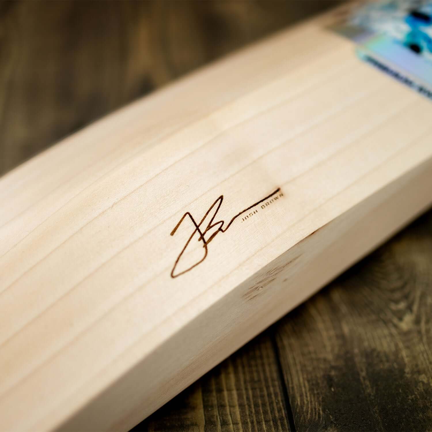 Close-up of JB140 Limited Edition cricket bat showing Josh Brown's signature engraved on the blade.