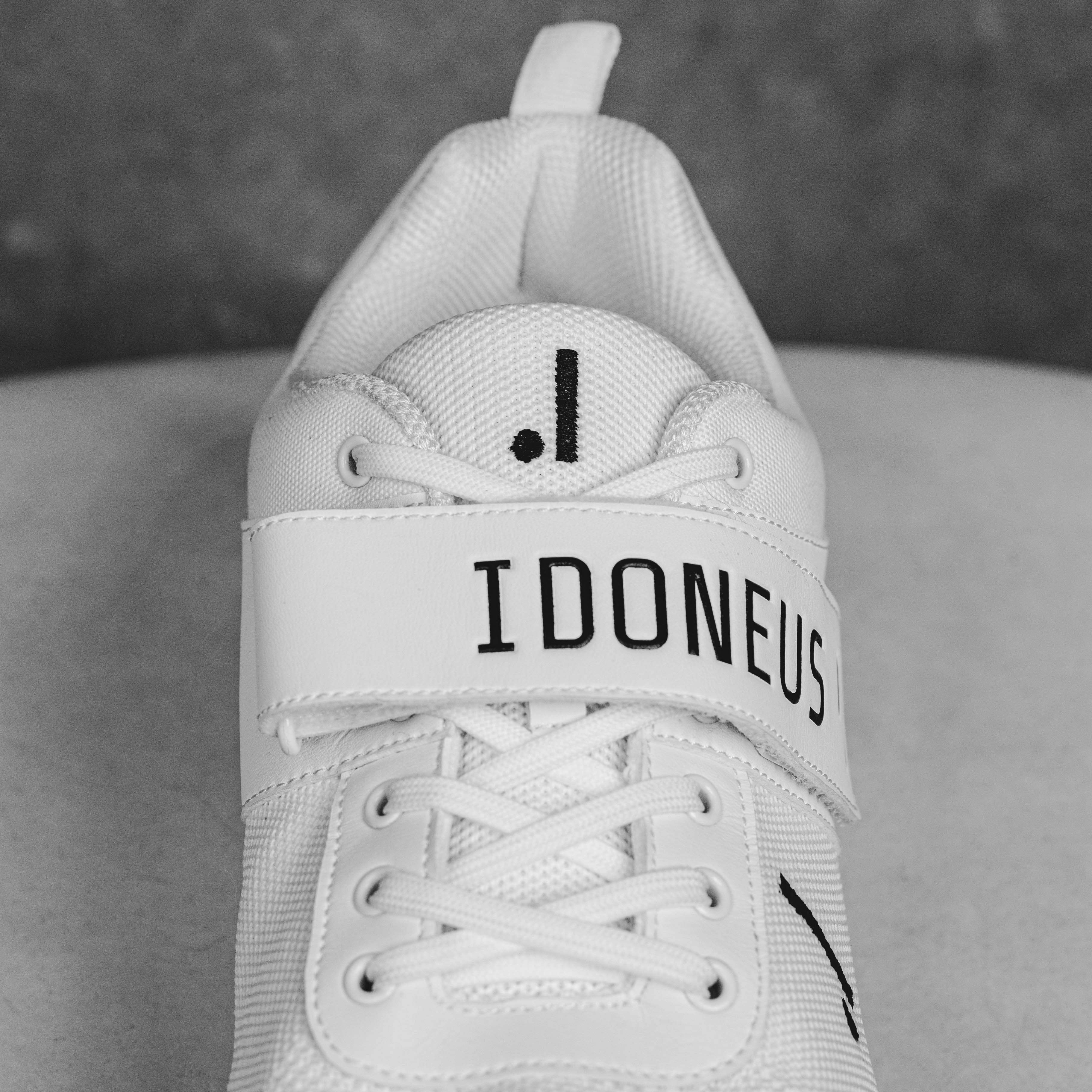 IDONEUS ID1 Cricket Shoe with durable laces and branding, featuring superior grip steel spikes for stability on various surfaces.