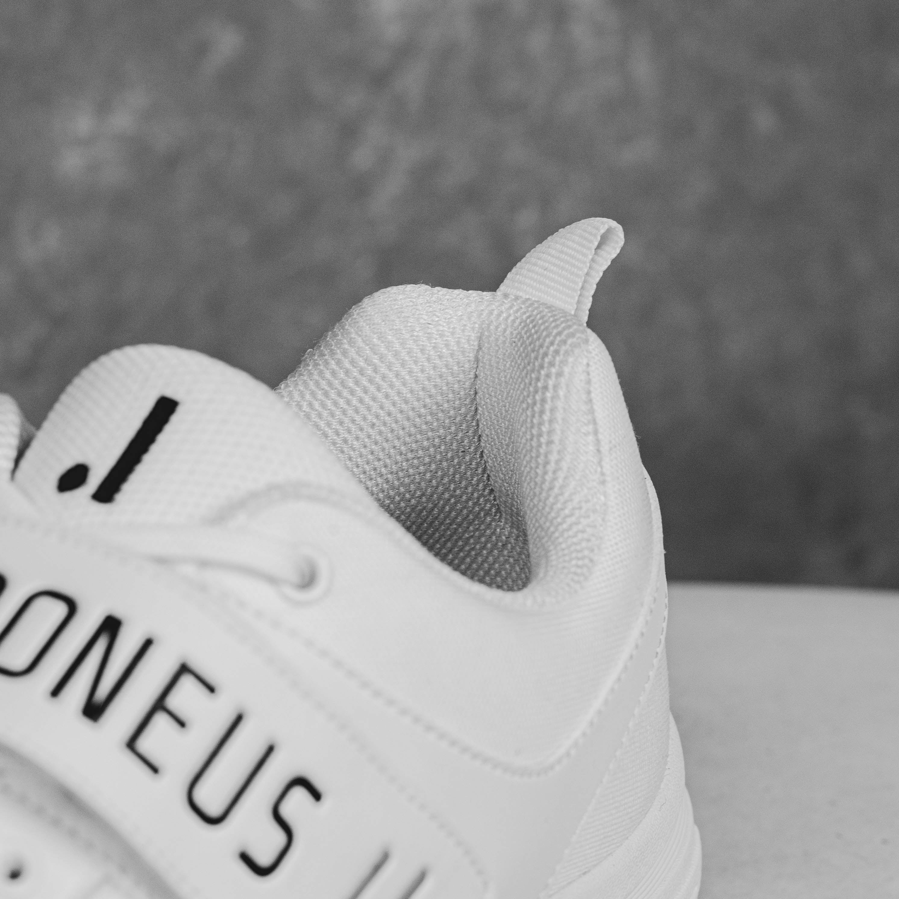 Close-up of IDONEUS ID1 Cricket Shoe highlighting durable material and steel spike design for superior grip and stability.