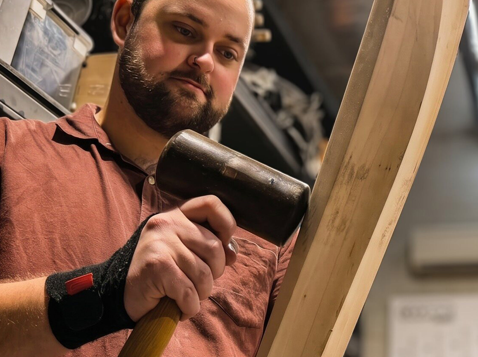 Knocking in a cricket bat by hand with a mallet